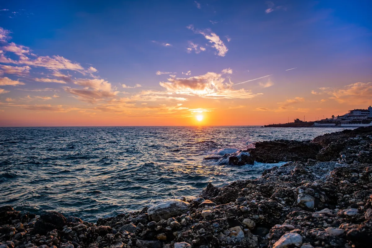 Rocky sunset coast at Banos del Carmen in Malaga