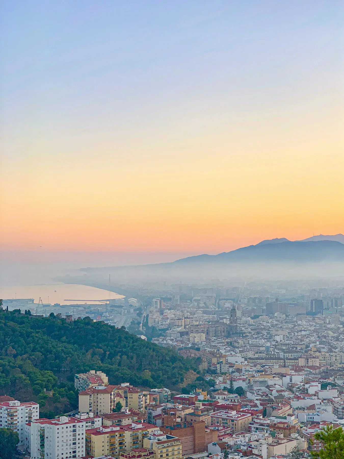 Malaga city and bay at sunset