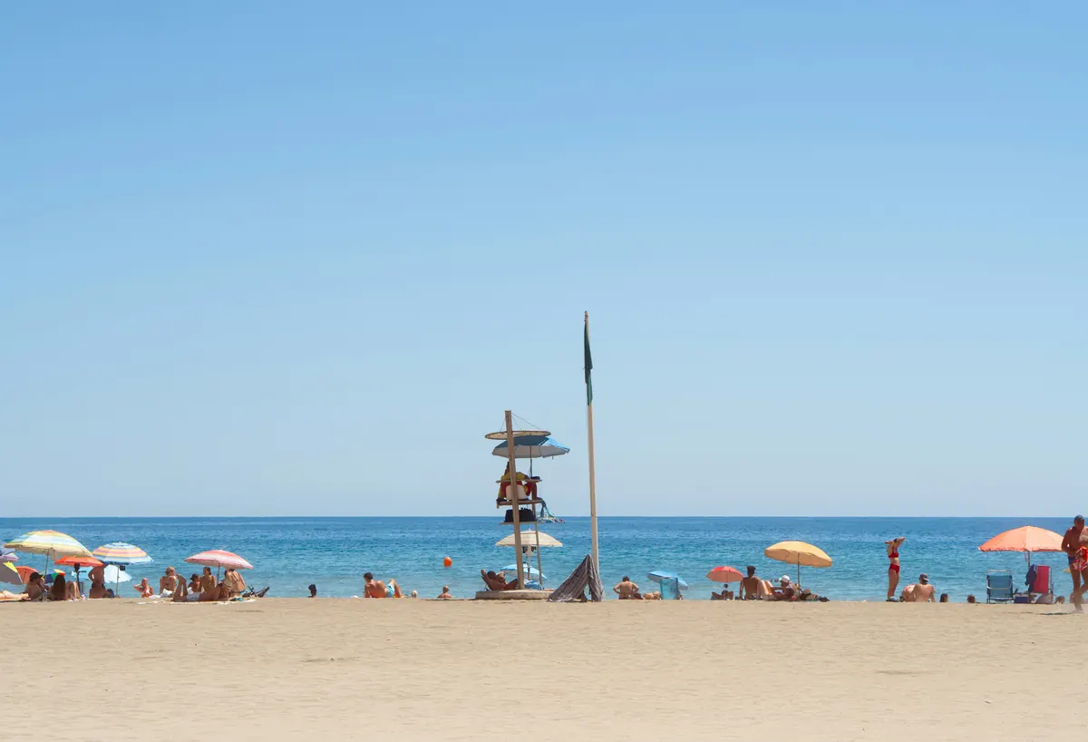 Families relaxing on La Malagueta beach in Malaga