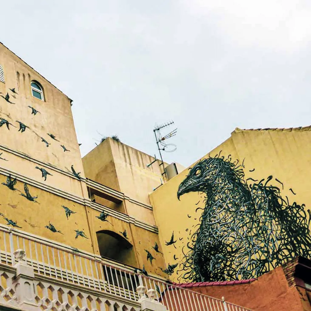 Bird mural across residential buildings in Malaga Soho