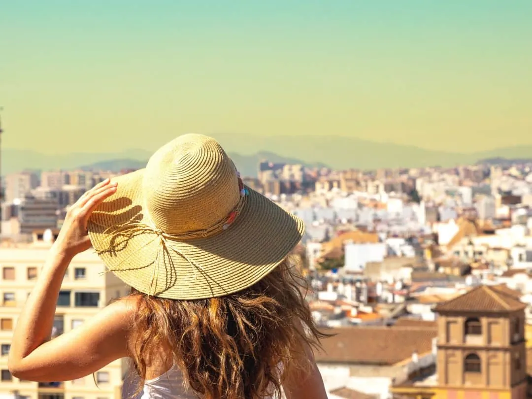 Solo traveller looking across Malaga from a viewpoint